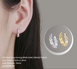 Silver hoop earring worn on an ear with a close-up inset showing gold and silver hoop earrings.