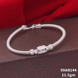 A silver snake chain bracelet with a central cylindrical charm and small bead accents, displayed on a dark textured surface with red fabric in the background. White text in the lower right reads '99AB144 11.